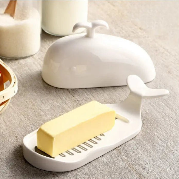 Butter dish with a stick of butter on a neutral background