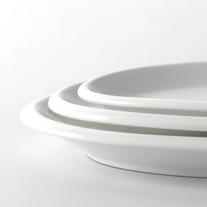 Close-up of a white ceramic bowl on a light gray background