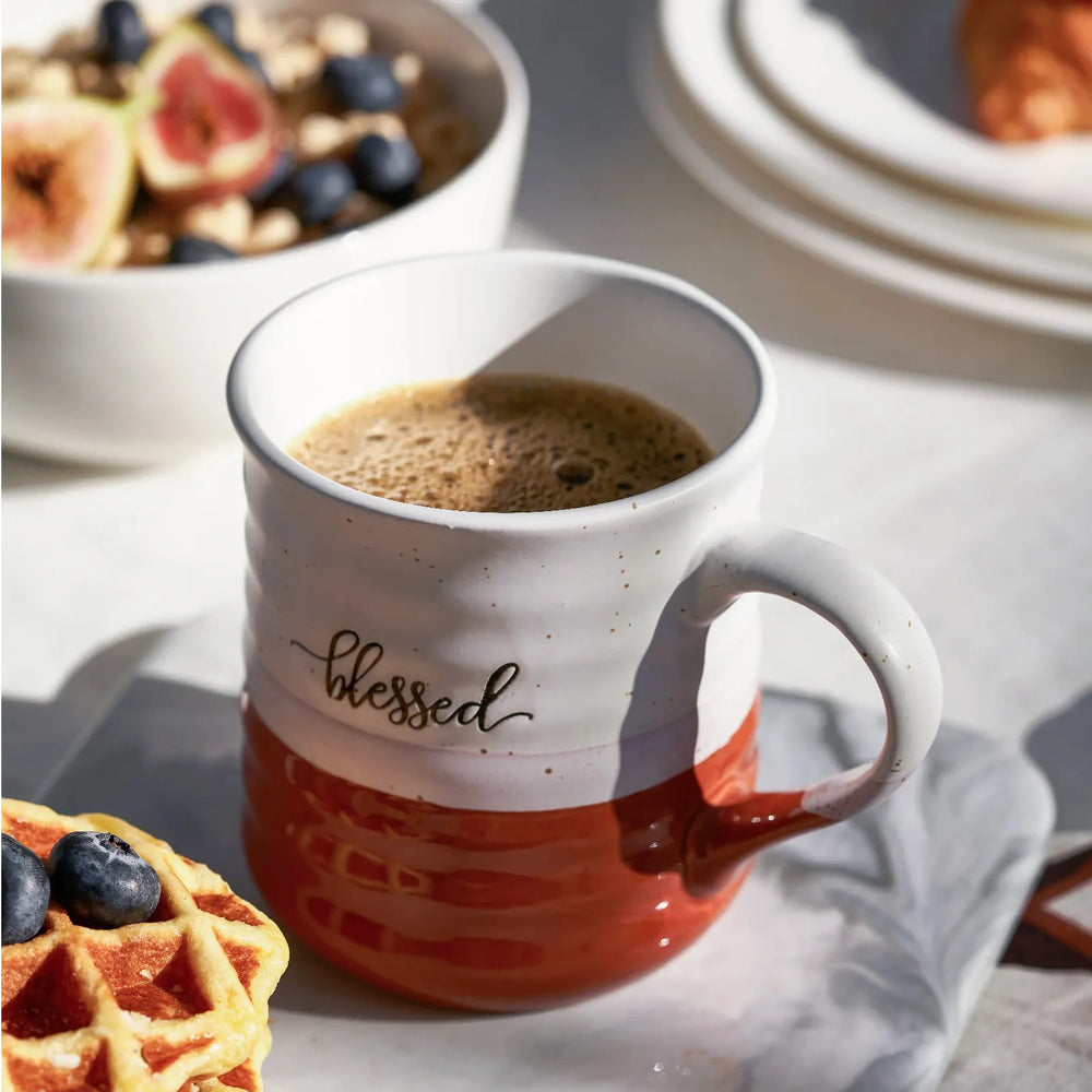 Two ceramic mugs with 'blessed' and 'grateful' text on a white background