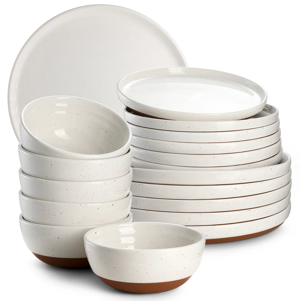 Set of white stoneware dinnerware with brown accents on a white background