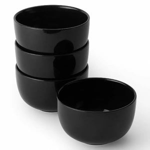 Set of four black bowls on a white background