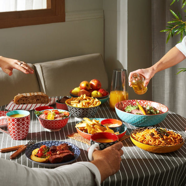 People enjoying a meal together at a table with various dishes and drinks.