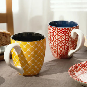 Two colorful coffee mugs on a table 