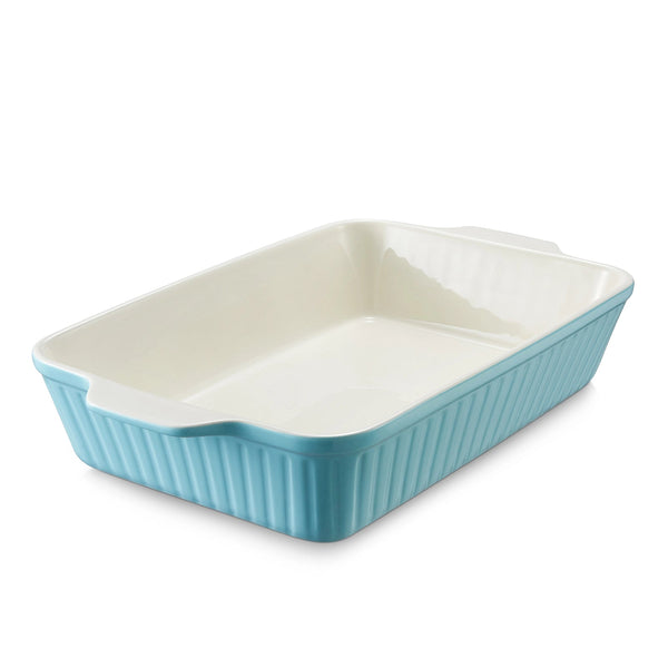 Rectangular ceramic baking dish with blue exterior and white interior on a white background